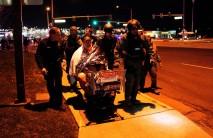 Patrick Carnes is evacuated in a Walmart cart by SWAT medics from the scene of a shooting at a Walmart where Carnes was shopping in Thornton, Colorado. Police are searching for a gunman who calmly walked into a Walmart in suburban Denver and opened fire with a handgun, randomly shooting at shoppers and store clerks, killing three people, before he fled.