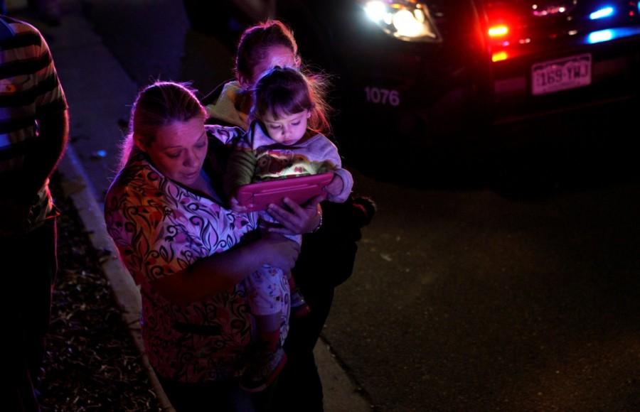 A woman who was shopping with her child during a shooting at a Walmart leaves the area in Thornton, Colorado. Colorado Walmart,Colorado Walmart shooting,casualties in Colorado Walmart shooting,Shooting at Colorado Walmart,suburban Denver