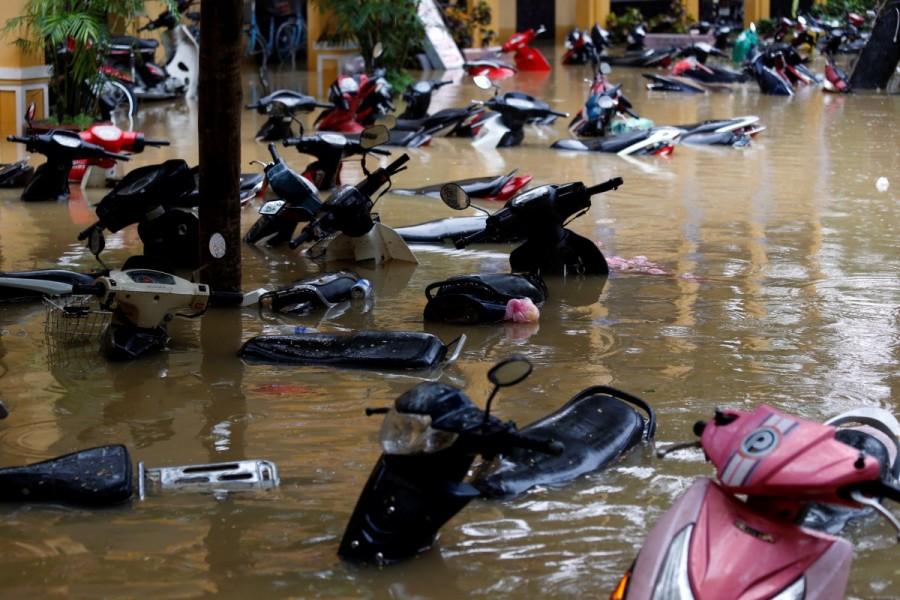 Motorbikes are seen along a flooded street in Hoi An. Vietnam,Vietnam after typhoon,Deadly flooding in Vietnam,Deadly flooding,Typhoon Damrey