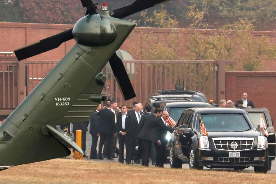 White House senior staff discuss the situation as President Trump sits in his car after being grounded from an attempt to visit the Demilitarized Zone dividing North Korea and South Korea, at a U.S. military post in Seoul. Trump’s secret attempt to visit the heavily fortified demilitarized zone was cancelled due to fog and mist. Fog forces,President Trump,Trump,Donald Trump