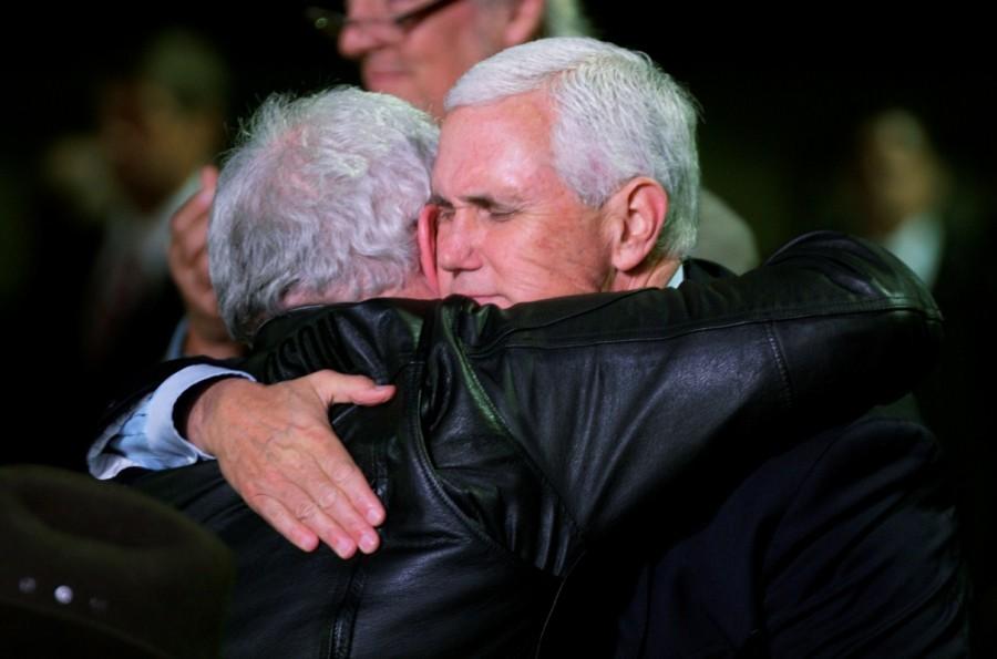 Vice President Mike Pence hugs Stephen Willeford, who who lived nearby and confronted the assailant with his own rifle when the gunman emerged from the church, shooting Kelley twice. Pence saluted the police, emergency personnel and doctors who had tended to the wounded, as well as the bravery of "those Texas heroes" - Willeford and Langendorff - who "pursued the attacker in a high-speed chase and saved the lives of Americans as a result." Mike Pence,Vice President Mike Pence,Mike Pence pays tribute in Texas