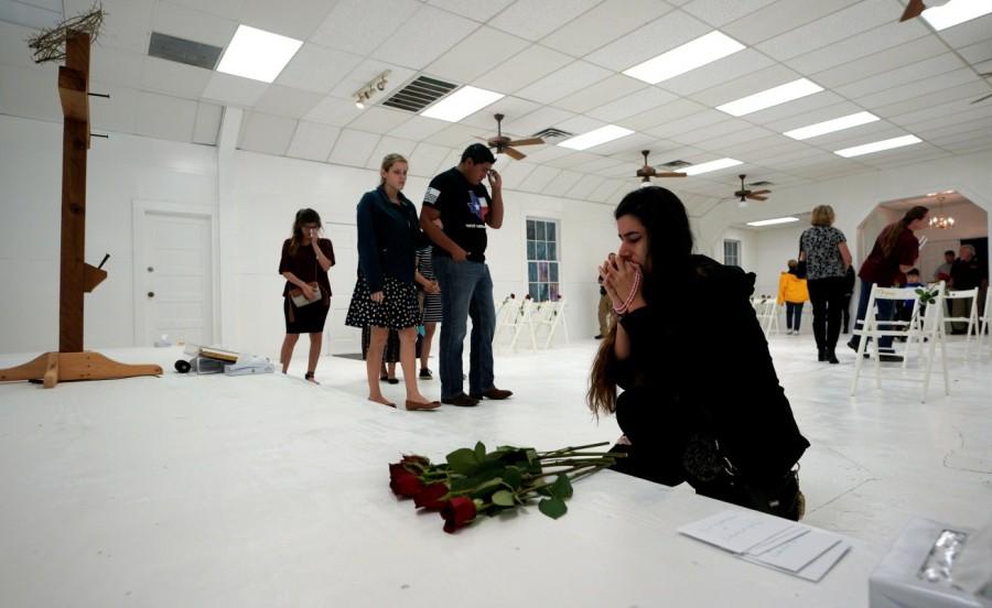 A woman prays in the First Baptist Church of Sutherland Springs. Texas church,Texas church reopens,Sutherland Springs,First Baptist Church