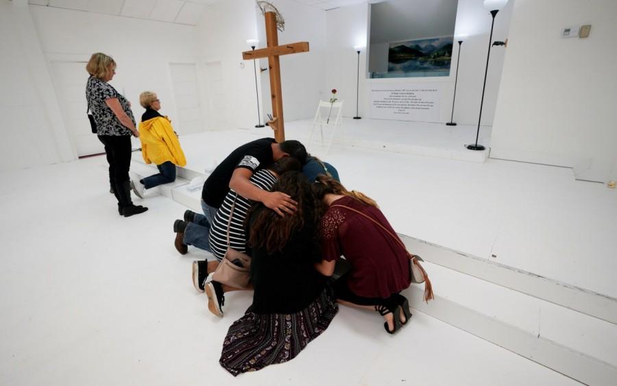 People pray in the First Baptist Church of Sutherland Springs where 26 people were killed in a shooting attack last week, as the church was opened to the public as a memorial to those killed, in Sutherland Springs, Texas. Texas church,Texas church reopens,Sutherland Springs,First Baptist Church