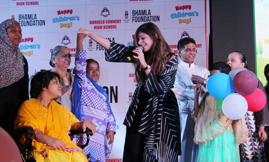 Kanika Kapoor shares a moment with the kids at Bhamla Foundation's Children's Day celebrations with spastic kids and kids from Duruelo Convent School, Bandra. Raveena Tandon,Kanika Kapoor,Asif Bhamla,Bhamla Foundation's Children's Day