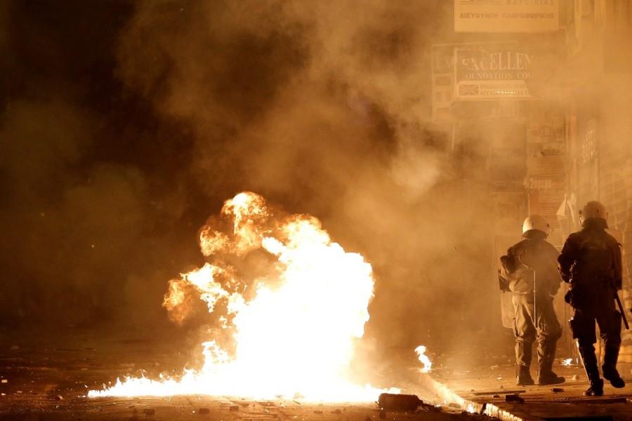 A petrol bomb explodes next to riot policemen during clashes following a rally marking the 44th anniversary of a 1973 student uprising against the military dictatorship that was ruling Greece, in Athens, Greece. Fiery protests,Greece,Greece protests,Protesters clash,Fiery protests in Greece
