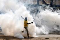 A man makes his way through rising tear gas fired by riot police officers to disperse supporters of Kenyan opposition leader Raila Odinga in Nairobi.