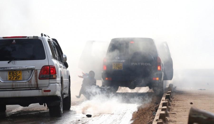 Kathiani Member of Parliament Robert Mbui is hit by another car as riot police disperse the convoy of Kenyan opposition leader Raila Odinga of the National Super Alliance (NASA) coalition, upon Odinga's return to Nairobi. Kenya,Kenya as violence,Kenyan opposition leader returns,Raila Odinga,Raila Odinga return