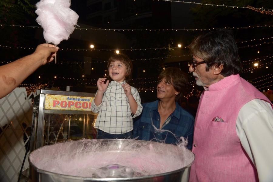 Amitabh Bachchan shared pics by tweeting: T 2716 - And as for this little bundle .. he wanted the fluffy 'buddhi ka baal' cone .. so we took him to the stall made one for him and the joy of getting it is just priceless .. Abram, jr Shahrukh .. delectable !! Aaradhya birthday bash,aaradhya birthday photos,Aaradhya birthday,Amitabh Bachchan and Shah Rukh Khan,Amitabh Bachchan,Shah Rukh Khan,Amitabh Bachchan and AbRam,Amitabh Bachchan and AbRam Khan,AbRam Khan