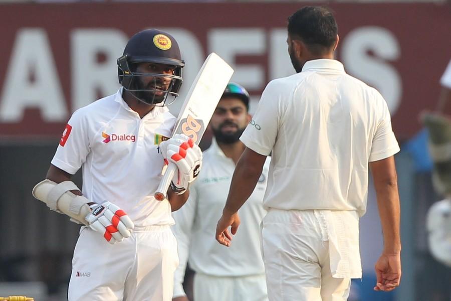 Angelo Mathews (12), who also batted well in the first innings scoring 52, did not survive a review after umpire Llong initially put his finger up to a lbw decision. Umesh Yadav was the bowler. Visiting captain Dinesh Chandimal (20 off 33; 3x4) and wicketkeeper-batsman Niroshan Dickwella (27) tried to stem the rot by stitching together a 47-run stand for the fifth wicket before Chandimal was castled by a 144 kmph Shami ripper. India vs Sri Lanka,India vs Sri Lanka 1st Test,Bhuvneshwar Kumar,Virat Kohli