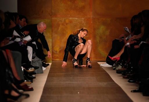 A model slips and falls while presenting a creation from the Herve Leger by Max Azria Fall 2009 collection during New York Fashion Week.