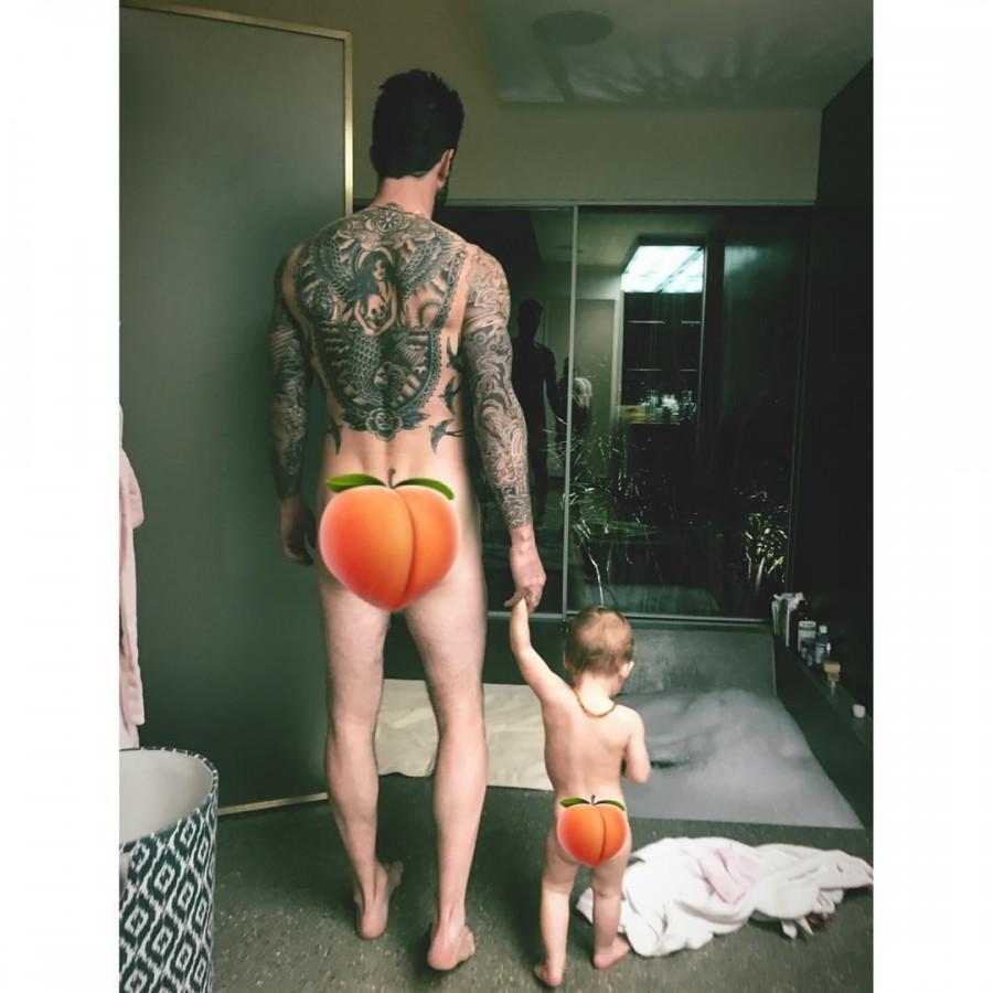 The image has been shared on Instagram by Levine's wife and model Behati Prinsloo, who currently expecting their second child, reports aceshowbiz.com. The image captures Levine and Rose from behind. Levine can be seen showing off his tattoo collection while holding his daughter's hand. Prinsloo covered their derriere with emojis of the peach fruit. "Same b**t different," Prinsloo captioned the image. Behati Prinsloo,Adam Levine,Adam Levine nude,Adam Levine nude pics,Adam Levine nude photo
