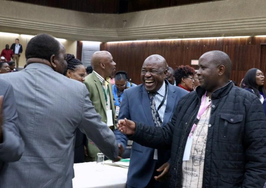 Zimbabwean War Veterans leader Chris Mutsvangwa (C) greets other delegates attending an extraordinary meeting of the ruling ZANU-PF party's central committee in Harare, Zimbabwe November 19, 2017. Zimbabwe's ruling party,Robert Mugabe,Zimbabwe's ruling party fires Robert Mugabe,Zimbabwe President Robert Mugabe