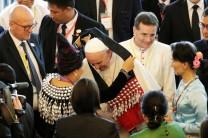 Pope Francis receives a bag as a gift as he arrives with Myanmar’s State Counsellor Aung San Suu Kyi for a meeting with members of the civil society and diplomatic corps in Naypyitaw, Myanmar November 28, 2017.