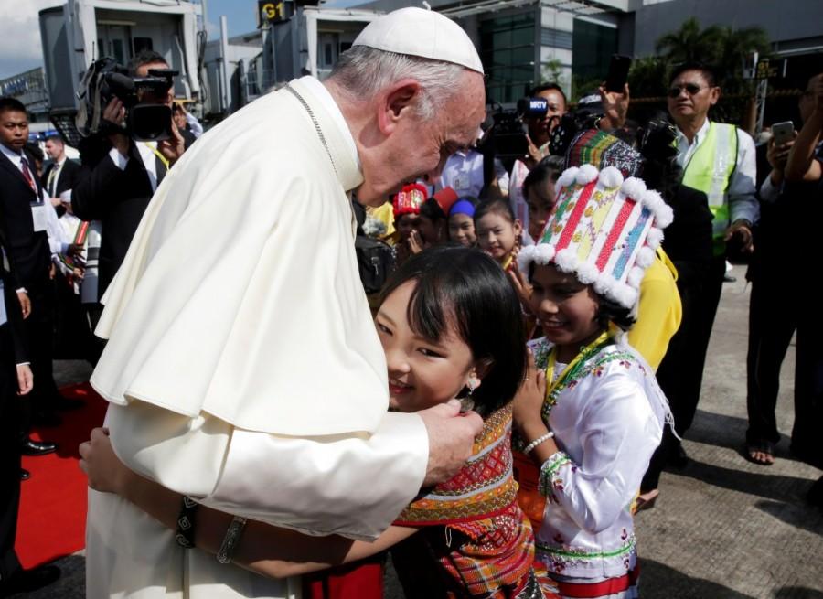 A girl embraces Pope Francis as he arrives at Yangon International Airport, Myanmar November 27, 2017. Pope Francis,Pope Francis visits Myanmar,Pope Francis visits Bangladesh