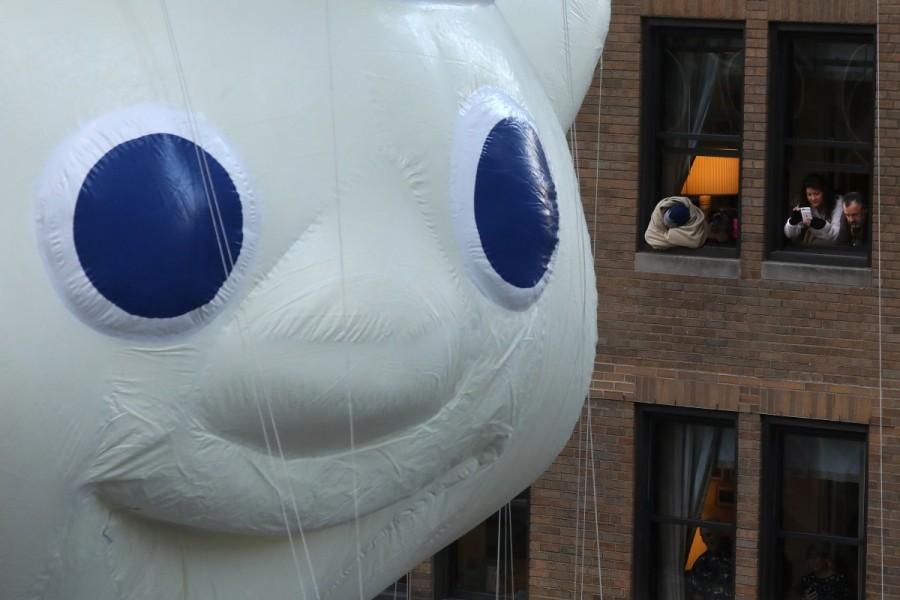 People take photos of the Pillsbury Doughboy balloon as it takes part in the 91st Macy's Thanksgiving Day Parade in New York, New York, U.S., November 23, 2017. Thanksgiving Day Parade,Thanksgiving Day,Macy's Thanksgiving Day Parade,Macy's Thanksgiving Day Parade pics,Macy's Thanksgiving Day Parade images,Macy's Thanksgiving Day Parade stills,Macy's Thanksgiving Day Parade pictures