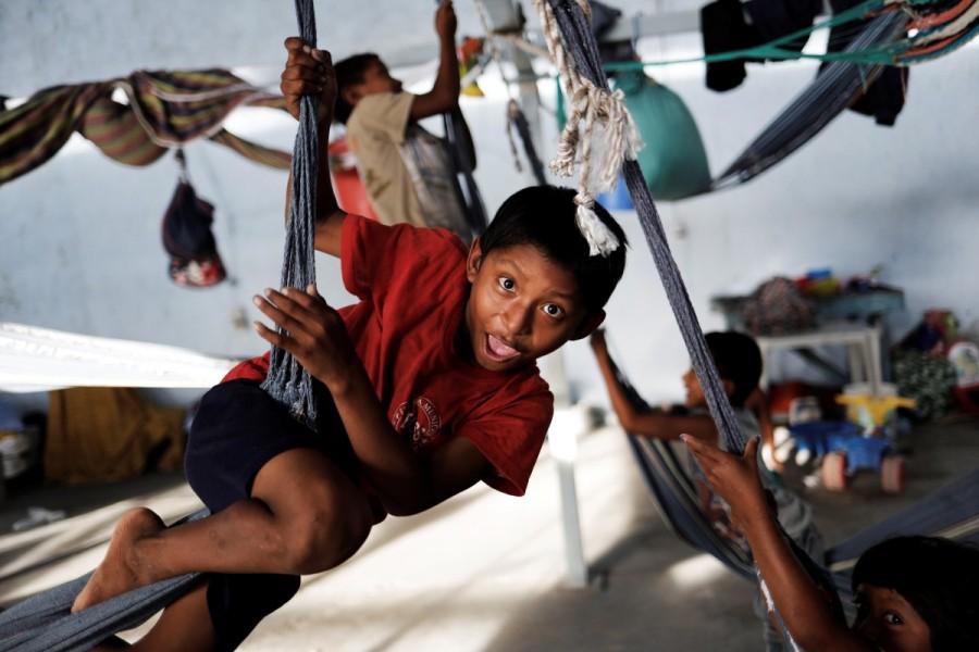 Indigenous Warao children play on hammocks at a shelter in Pacaraima, Roraima state, Brazil. Driven by hunger and illness from their traditional homeland on the Orinoco River delta in northeastern Venezuela, more than 1,200 members of the Warao tribe migrated to northern Brazil to live and beg on the streets. Venezuela's indigenous,Venezuela indigenous,Venezuela,Orinoco River delta,Warao tribe