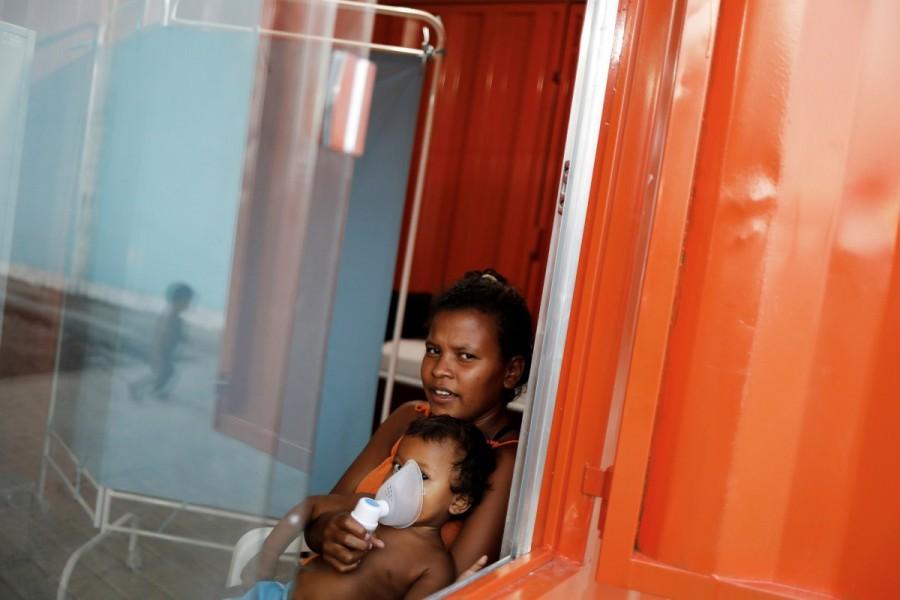 An indigenous Warao child receives nebulizer therapy by his mother at a shelter in Pacaraima, Roraima state, Brazil. "They were already begging in Venezuela, but those who gave them money are themselves asking for help today," said Sister Clara, a missionary from Brazil-based humanitarian organization Fraternidade that runs two shelters for the Warao. "Who in today's crisis in Venezuela is going to buy Warao arts and crafts?" she said. Venezuela's indigenous,Venezuela indigenous,Venezuela,Orinoco River delta,Warao tribe