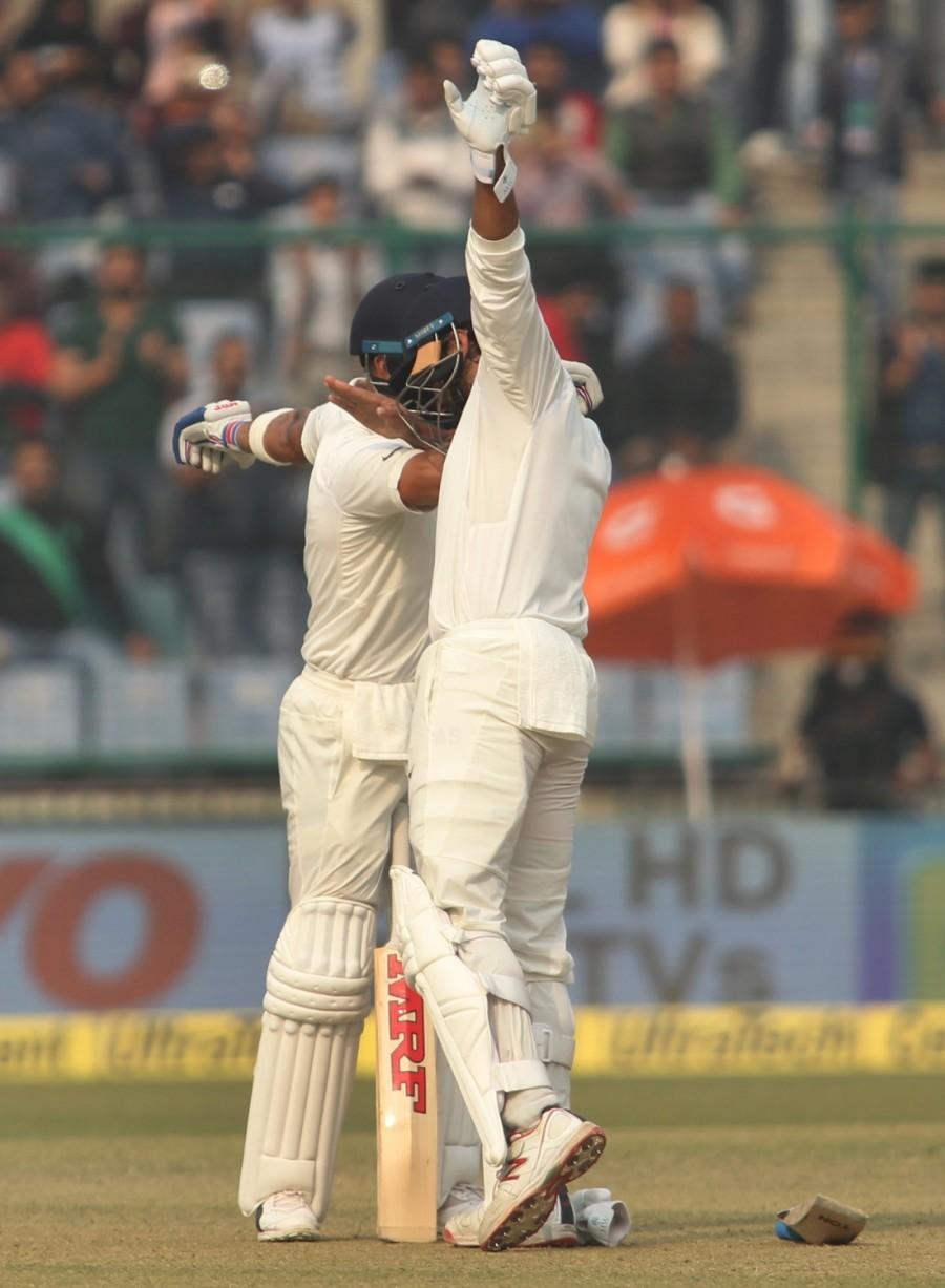 Indian skipper Virat Kohli celebrates Murali Vijay's century with him on Day 1 of the third test match between India and Sri Lanka at Feroz Shah Kotla Stadium in New Delhi on Dec 2, 2017. Virat Kohli,Virat Kohli record,Virat Kohli record double centuries,Virat Kohli double centuries,Sachin Tendulkar,Virender Sehwag