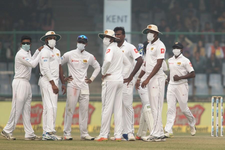 The air quality in the capital deteriorated to an alarming level on a hazy Sunday, forcing Sri Lankan cricketers to cover their faces with anti-pollution masks in a Test match at Delhi's Feroz Shah Kotla stadium. Amid hazy conditions, the second session of the third and final Test match between India and Sri Lanka was halted for few minutes. Sri Lankan players wear face masks,India vs Sri Lanka,India vs Sri Lanka 2017,India vs Sri Lanka 3rd Test,Delhi pollution,Delhi smog,delhi air pollution