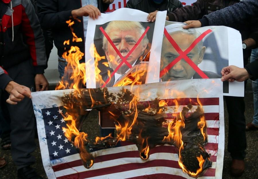 Palestinians burn posters depicting Israeli Prime Minister Benjamin Netanyahu and President Donald Trump during a protest against the U.S. intention to move its embassy to Jerusalem and recognize the city as the capital of Israel, in Rafah in the southern Gaza Strip. Donald Trump,President Donald Trump,Jerusalem decision,Jerusalem,jerusalem violence