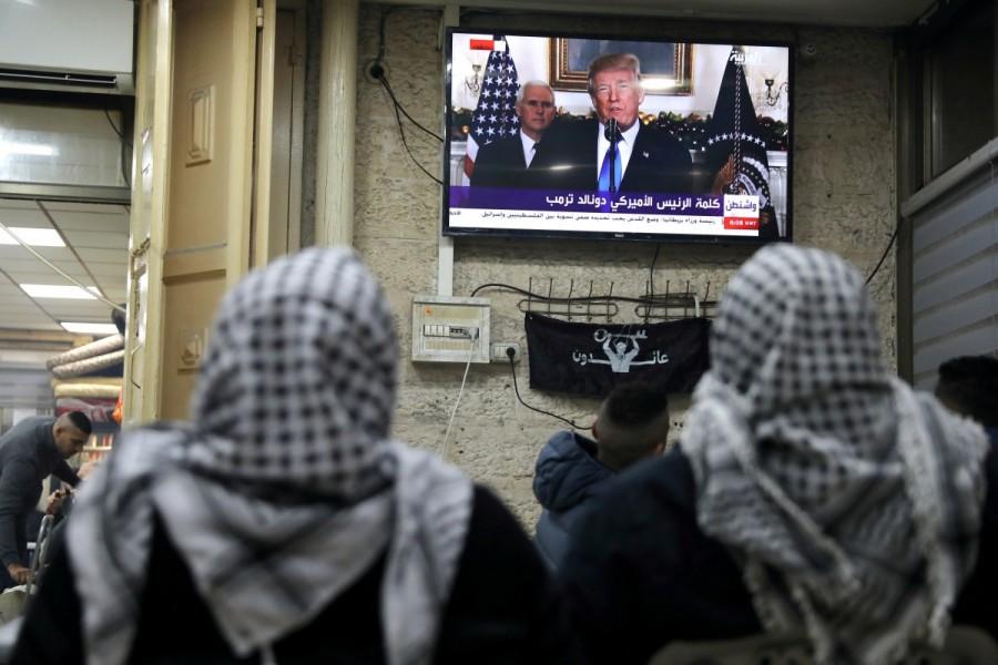 Palestinians watch a televised broadcast of President Donald Trump delivering an address, in Jerusalem's Old City. Donald Trump,President Donald Trump,Jerusalem decision,Jerusalem,jerusalem violence