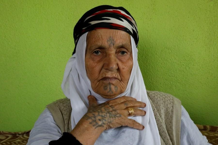 Ayse Yusufoglu, 84, poses as she speaks about her tattoos at her home in Alakus village near Kiziltepe, a town in southeastern province of Mardin, Turkey, November 21, 2017. When Yusufoglu was a girl, she and her friends in southeast Turkey tried to win the hearts of young men in their village using breast milk and soot. Tattooed women,Ayse Yusufoglu,Turkey women