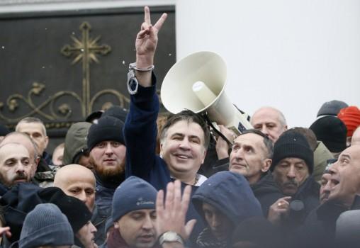 Georgian former President Mikheil Saakashvili flashes a victory sign after he was freed by his supporters in Kiev, Ukraine December 5, 2017.