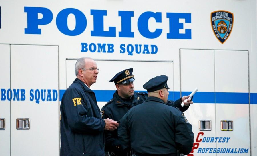 Police officers and an FBI agent stand outside the New York Port Authority. Explosion rocks,New York,New York Port Authority