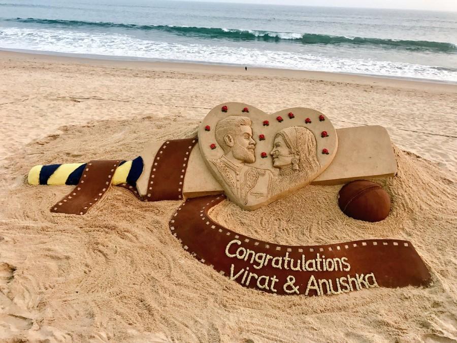 Sand artist Sudarsan Pattnaik has wished newly weds cricket star Virat Kohli and actress Anushka Sharma with this stunning art. Anushka Sharma-Virat Kohli marriage,Anushka Sharma-Virat Kohli wedding,Sand artist Sudarsan Pattnaik,Sudarsan Pattnaik,Anushka Sharma-Virat Kohli sand art