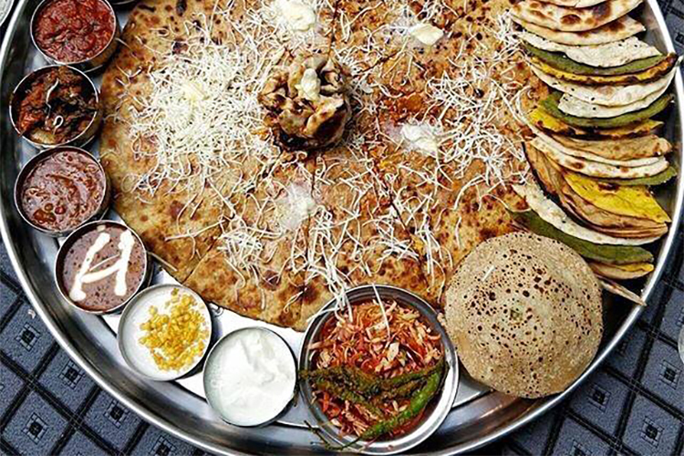 Fans have named an eating thali by the name "Baahubali Thali": We all know how much youngsters these days love food. Rajesh Patel and Manish Patel, owners of Rajwadu, decided on doing something to justify the legacy of Baahubali and of course our very own Prabhas and what better than a thali, dedicated to Baahubali, depicting the grandness of the franchise! The same has taken place in Pune as well where a big Thali is named as Baahubali thali thanks to its widespread delicious dishes. Baahubali star Prabhas,Prabhas,Prabhas fans,Baahubali 2,Baahubali The Conclusion