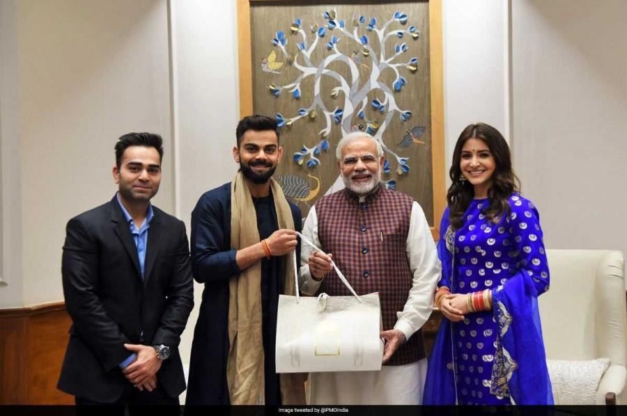 Prime Minister Narendra Modi on Wednesday met newly-married Indian cricket captain Virat Kohli and his Bollywood actress wife Anushka Sharma and congratulated the couple. Along with the couple, Kohli's brother Vikas was also present during the meet. Virat Kohli,Anushka Sharma,Virat Kohli and Anushka Sharma,Virat Kohli Wedding Reception,Sharma Wedding Reception,Narendra Modi