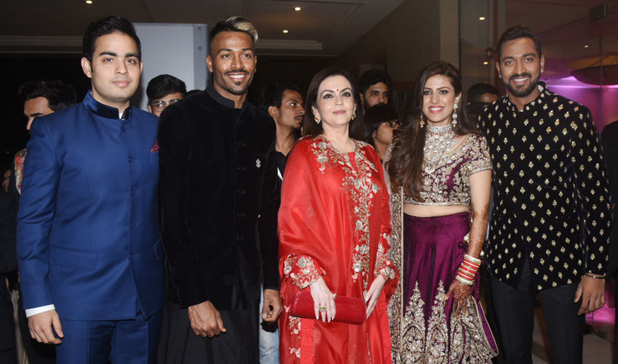 Akash Ambani, Hardik Pandya, Nita Ambani, Pankhuri Sharma and Krunal Pandya pose for the photographers during wedding reception at JW Marriott hotel in Mumbai. Amitabh Bachchan,Rohit Sharma,Irfan Pathan,Hardik Pandya,Elli AvrRam,Krunal Pandya and Pankhuri Sharma,Krunal Pandya and Pankhuri Sharma wedding reception,Krunal Pandya and Pankhuri Sharma reception,Krunal Pandya wedding reception,Pankhuri Sharma wedding