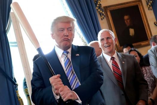 ice President Mike Pence laughs as U.S. President Donald Trump holds a baseball bat as they attend a Made in America product showcase event at the White House in Washington, U.S., July 17, 2017. Carlos Barria: 