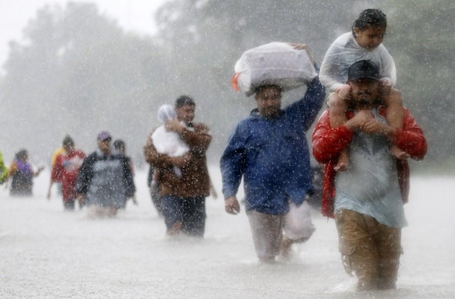 Residents wade through flood waters from Tropical Storm Harvey in Beaumont Place, Houston, Texas, U.S., August 28, 2017. Natural disasters of 2017,disasters in 2017,2017 natural disasters,2017 disasters