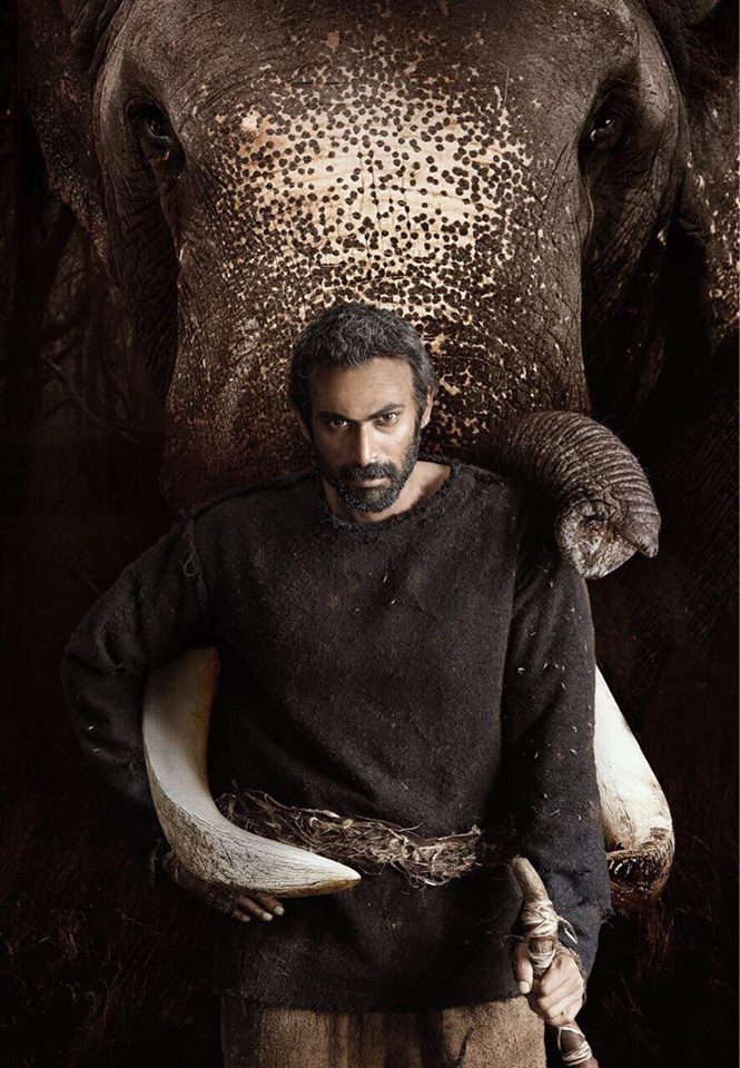 Rana sports a rugged look for the movie, in which he will be seen essaying the character of Bandev. The movie is a trilingual remake of late actor Rajesh Khanna's 1971 film "Haathi Mere Saathi". Rana can be seen leaning on the trunk of an elephant in the first look. "Entering the new year with a great new story to tell. Introducing Bandev from 'Haathi Mere Saathi'," he captioned the image. The film will be a tribute to the old classic. It will be shot in Hindi, Telugu and Tamil with Rana in the lead. Inspired from true events, the remake will be helmed by Prabhu Solomon. The filming of the remake will commence in Thailand and then travel to various locations across India. "Haathi Mere Saathi" is slated to release on Diwali. Haathi Mere Saathi first look,Haathi Mere Saathi first look poster,Haathi Mere Saathi poster,Rana Daggubati,Rana Daggubati as Bandev,Bandev