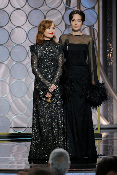Presenters Isabelle Huppert and Angelina Jolie speak onstage during the 75th Annual Golden Globe Awards at The Beverly Hilton Hotel on January 7, 2018 in Beverly Hills, California. Angelina Jolie,Angelina Jolie son,Angelina Jolie son Maddox,Maddox,Angelina Jolie at Golden Globes 2018,Golden Globes 2018,celebs at Golden Globes 2018