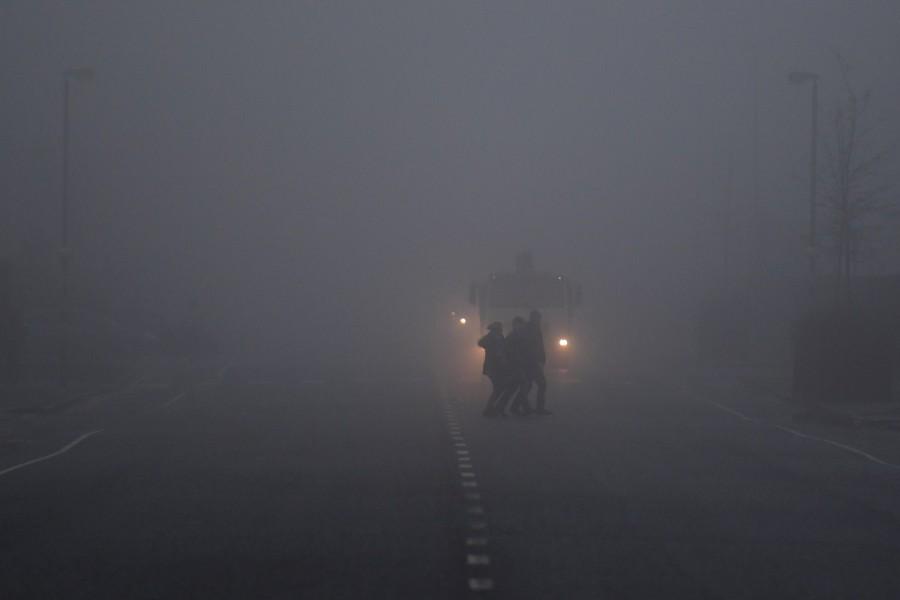 People cross a road in front of a truck in heavy fog in Belfast, Northern Ireland, January 10, 2018. Northern Ireland,Ireland,fog,Ireland hidden in fog