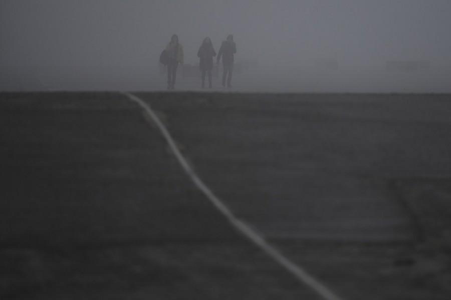 People walk through heavy fog in Belfast, Northern Ireland, January 10, 2018. Northern Ireland,Ireland,fog,Ireland hidden in fog