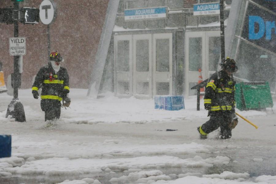 Boston firefighters wade through a street flooded from tidal surge in Boston. U.S. Northeast,Blizzard roars,Blizzard roars in US