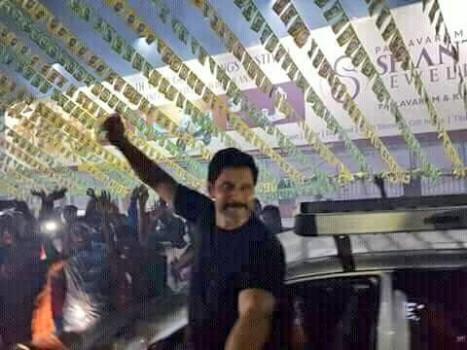 Chiyaan Vikram waves to the fans as he arrives at Vettri Theatre for Sketch FDFS in chennai.
