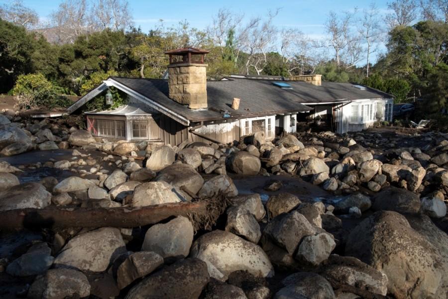 Montecito firefighters walk on a road damaged by mudslides in Montecito, California, U.S., January 10, 2018. Deadly mudslides,mudslides,Southern California,Southern California mudslides