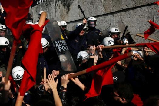 Protesters clash with riot police during a demonstration outside the parliament building against planned government reforms in Athens.