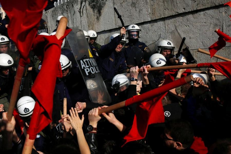 Protesters clash with riot police during a demonstration outside the parliament building against planned government reforms in Athens. Protests and clashes,Protests in Athens,clashes in Athens,Athens parliament