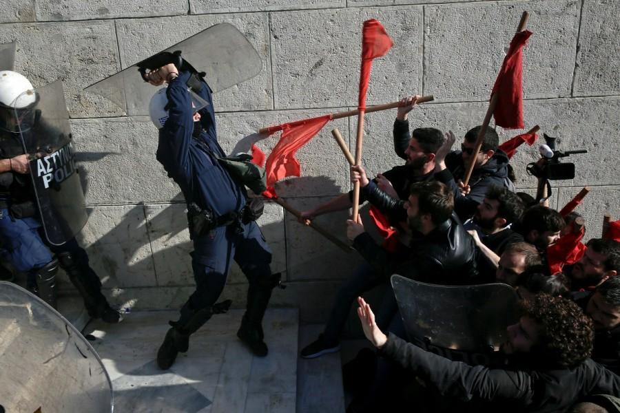 Protesters clash with riot police during a demonstration outside the parliament building against planned government reforms in Athens. Protests and clashes,Protests in Athens,clashes in Athens,Athens parliament