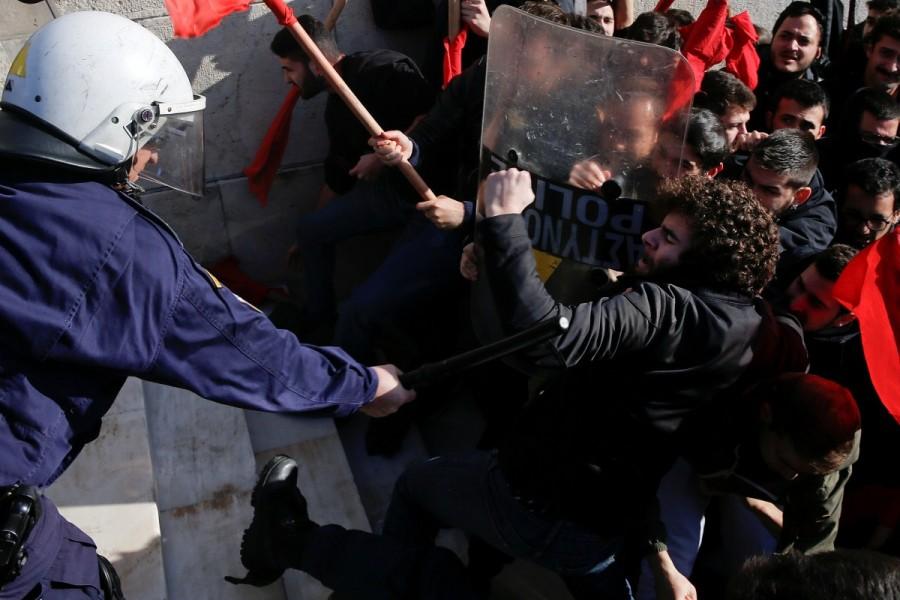 Protesters clash with riot police during a demonstration outside the parliament building against planned government reforms in Athens. Protests and clashes,Protests in Athens,clashes in Athens,Athens parliament