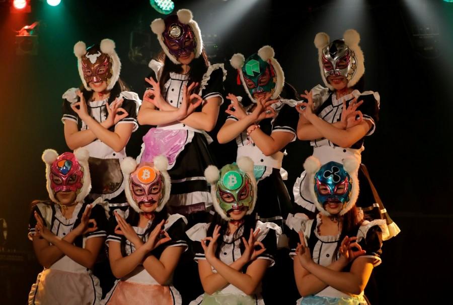 In their debut, the eight "Virtual Currency Girls", or Kasotsuka Shojo in Japanese, cavorted in maid costumes with frilly skirts and full-face professional wrestling-style masks with fuzzy pom-pom ears, extolling the virtues of decentralized digital currencies such as bitcoin. Virtual Currency Girls,Japan's Virtual Currency Girls,Japan's newest idol group,Japan new idol group
