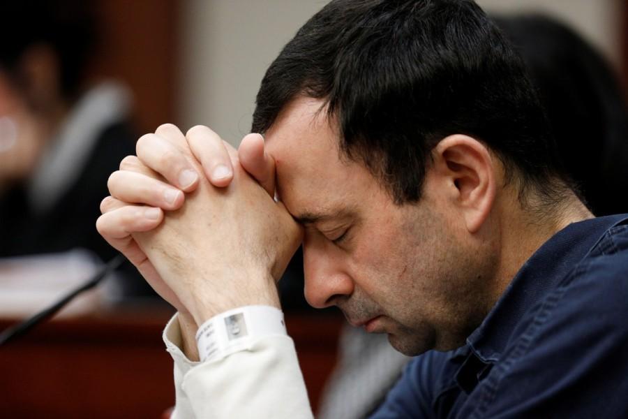 Dr. Larry Nassar listens to a victim during his sentencing hearing. Nassar, 54, the national medical coordinator for USA Gymnastics and prominent physician at Michigan State University's sports clinic, pleaded guilty to 10 counts of first-degree criminal sexual assault before Aquilina in November. He is already serving a 60-year prison sentence after pleading guilty in July to child pornography charges in federal court. Nassar has sat through the proceedings with his head bowed, not making eye contact with the victims. He apologized for his crimes at the November hearing, local media reported. Larry Nassar,US Gymnastics Larry Nassar,Larry Nassar victims,USA Gymnastics team,sexual assault