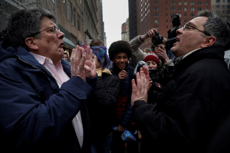 A supporter of President Donald Trump (R) argues with a protester as New York City high school students look on during a protest against Trump's immigration policies in lower Manhattan, New York. Supporters,Trump,Donald Trump,US President Donald Trump,polarized politics