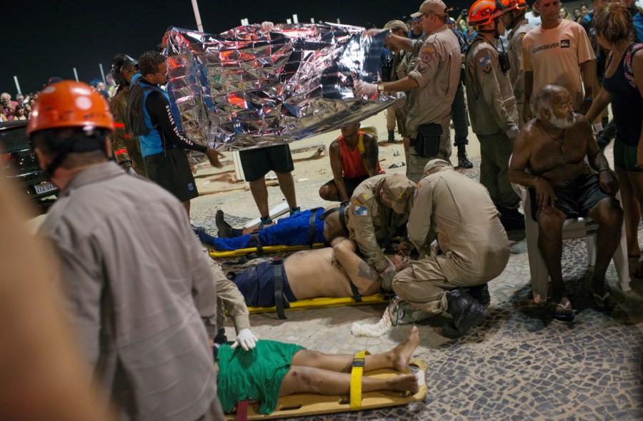 Paramedics help the injured after a vehicle ran over some people at Copacabana beach in Rio de Janeiro, Brazil January 18, 2018. Car plows,crowded sidewalk,Copacabana beach,Driver ploughs,Rio de Janeiro car incident,Rio de Janeiro,Car plows into crowd