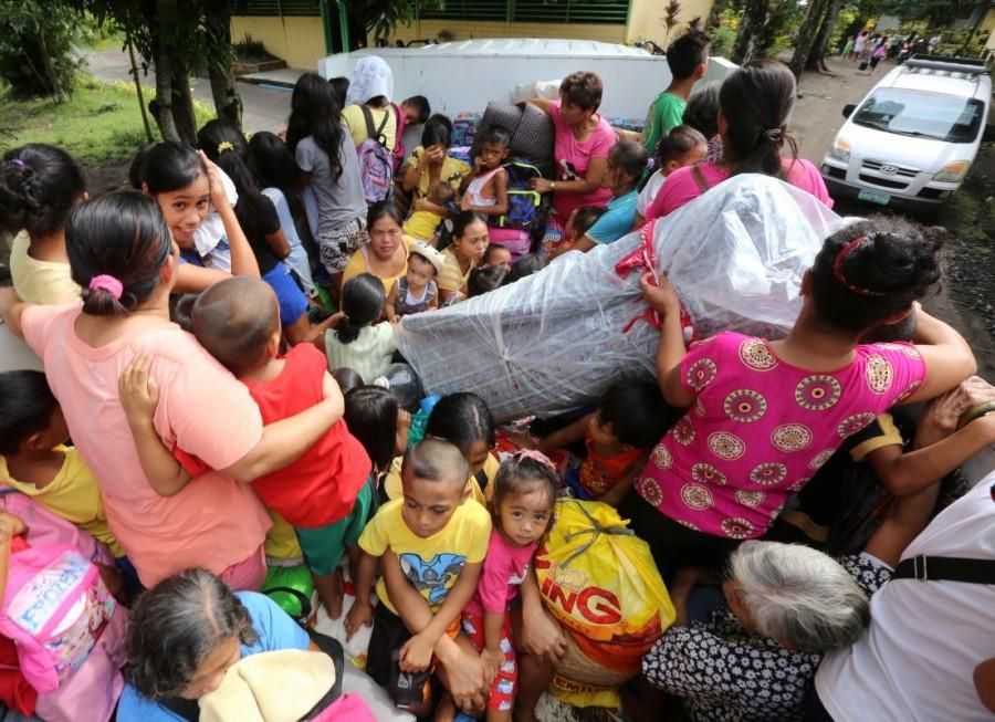Evacuees with their belongings on a military truck as they prepare to depart to the evacuation center after Mayon volcano erupted anew, in Camalig town, Albay province, Philippines January 16, 2018. Volcano in Philippines,volcano,volcano eruption,Mayon volcano spews,Mayon volcano